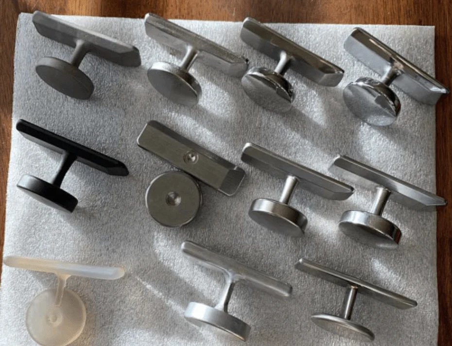 Twelve Ttool prototypes in different materials and shapes laid out on a white towel